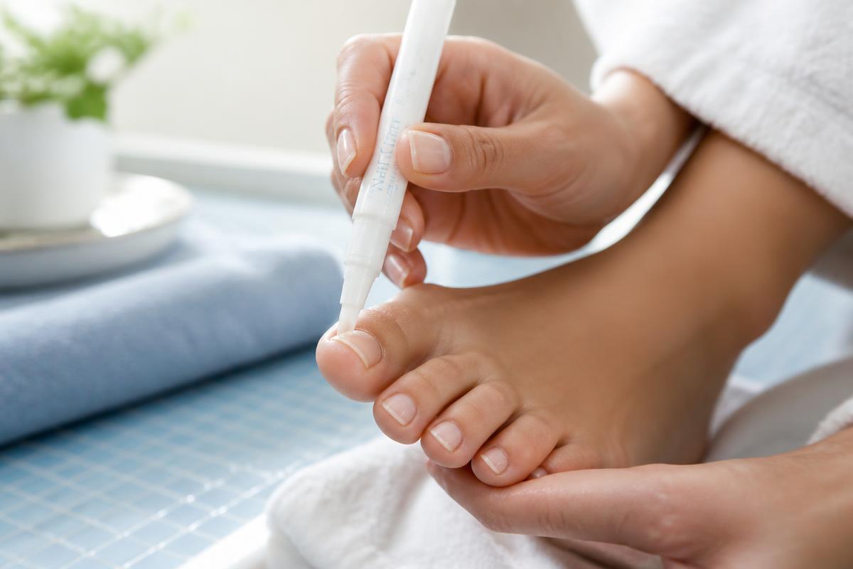 Applying the Orivelle nail care pen to a clean, dry nail